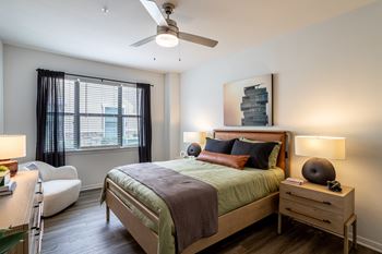 Bedroom with oversized windows with curtains at Grand Villas at Cinco Ranch, Katy